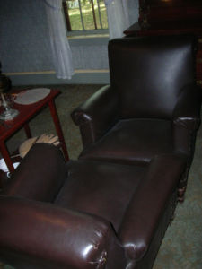 two plush leather chairs facing each other, their fronts touching